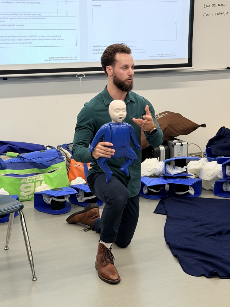 Alder founder Nick demonstrating choking response on a child manikin at Langara College